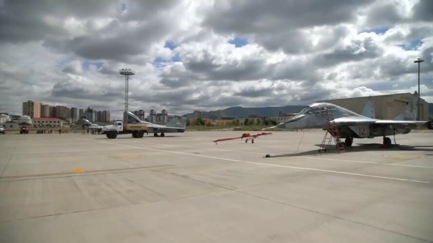 Mongolian MiG-29UB (12 red & two more) on parking.jpg