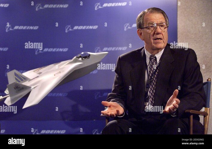 boeing-vice-chairman-harry-stonecipher-gestures-while-sitting-near-a-model-of-his-companys-x-3...jpg