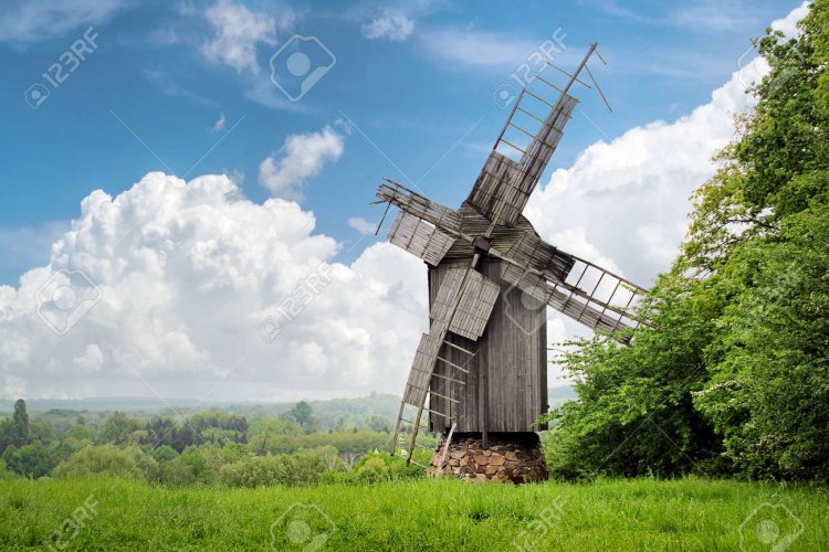 138345318-old-destroyed-wooden-windmill-on-the-background-of-a-beautiful-rustic-summer-landscape.jpg
