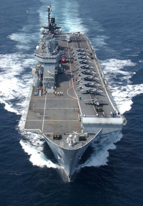 USMC_Harriers_line_the_deck_of_HMS_Illustrious_MOD_45147594.jpg