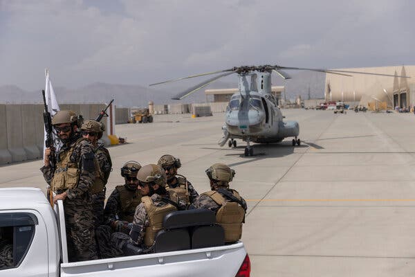 Taliban fighters on Tuesday secured helicopters that had been disabled and left behind by American forces at the Kabul airport.